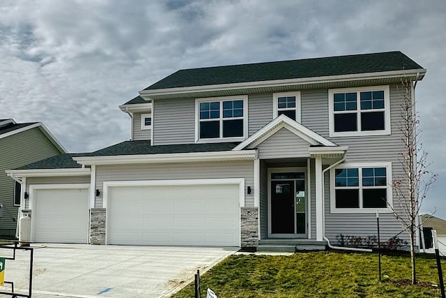 view of front of house featuring a front yard and a garage