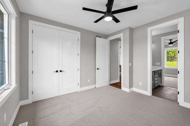 unfurnished bedroom with a closet, carpet, and ceiling fan