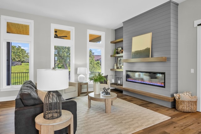 living room with plenty of natural light, a fireplace, and hardwood / wood-style floors