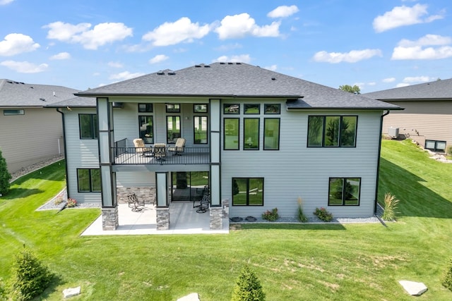 rear view of property featuring a patio and a yard