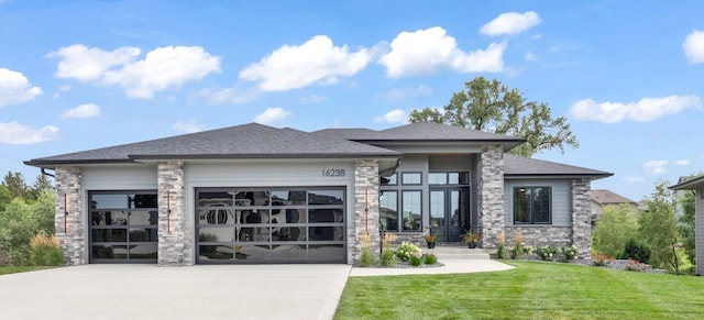 view of front of house featuring a garage and a front lawn