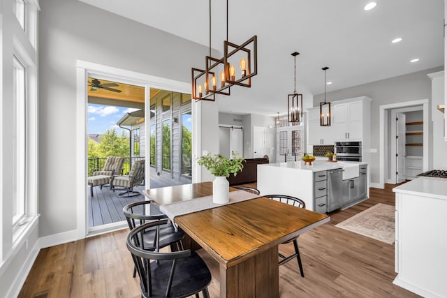 dining area featuring light hardwood / wood-style floors and ceiling fan