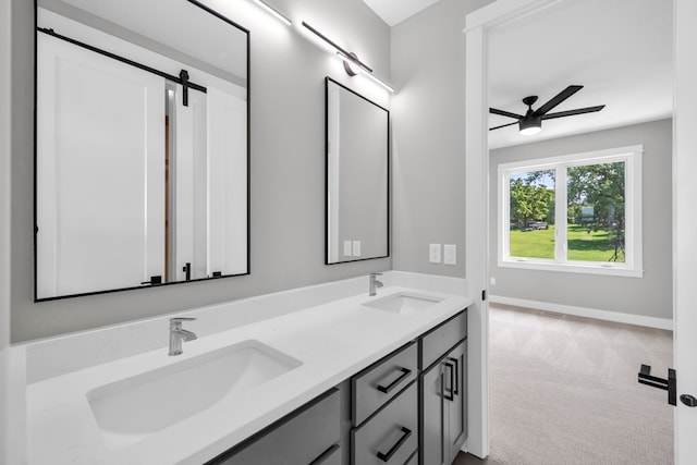 bathroom featuring ceiling fan and dual bowl vanity