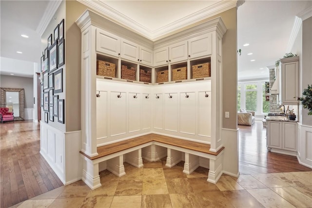 4701 150th St, Urbandale, IA 50323 - mudroom with crown molding, a decorative wall, a wainscoted wall, recessed lighting, and light wood-style floors