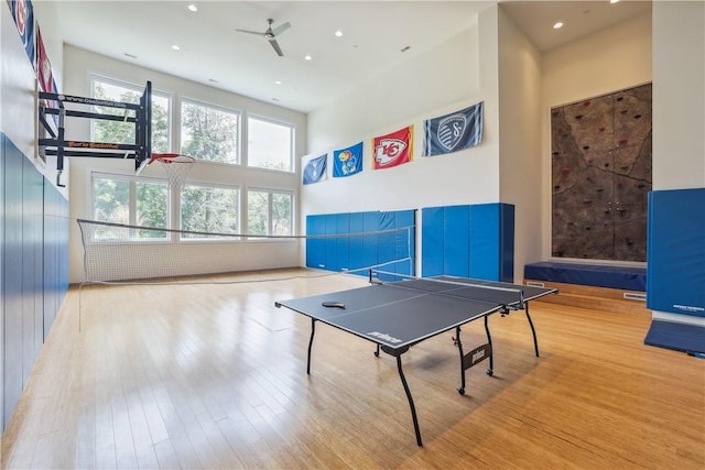 4701 150th St, Urbandale, IA 50323 - recreation room featuring healthy amount of natural light, a towering ceiling, ceiling fan, wood finished floors, and recessed lighting