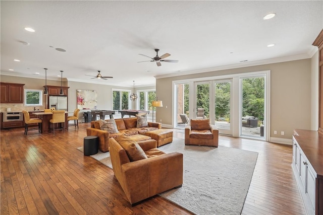 4701 150th St, Urbandale, IA 50323 - living room with hardwood / wood-style floors, plenty of natural light, crown molding, recessed lighting, and baseboards