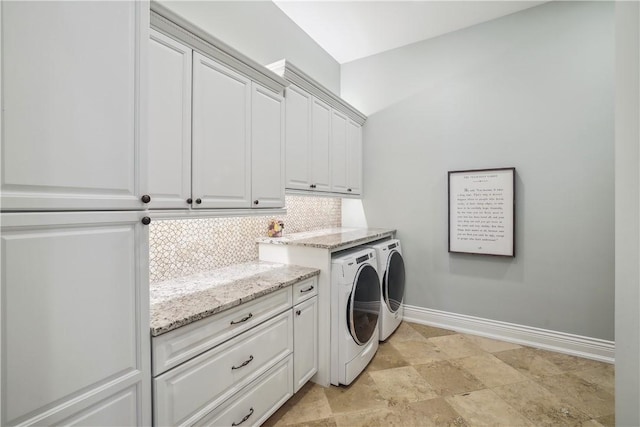 4701 150th St, Urbandale, IA 50323 - laundry room with washing machine and clothes dryer, cabinet space, baseboards, and stone finish flooring