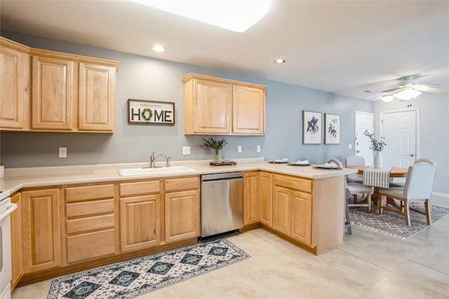 kitchen featuring a peninsula, light brown cabinetry, a sink, light countertops, and stainless steel dishwasher