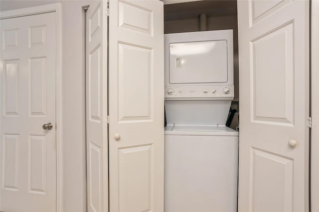 laundry room featuring laundry area and stacked washer / dryer