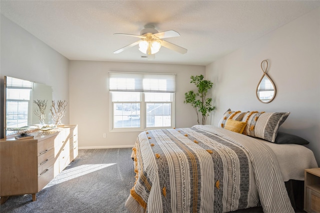 carpeted bedroom with a ceiling fan and baseboards