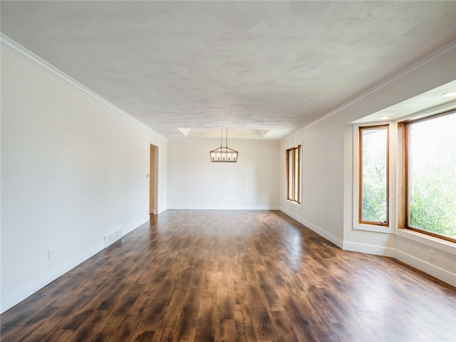 unfurnished room featuring wood-type flooring, ornamental molding, and an inviting chandelier