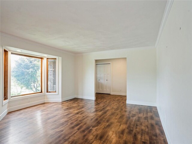 unfurnished room featuring hardwood / wood-style flooring and crown molding