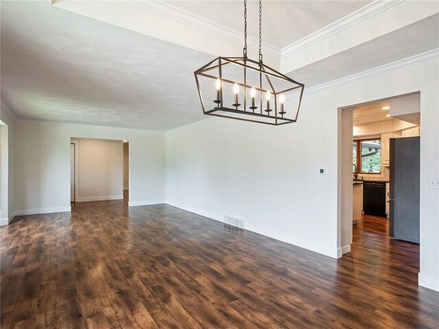 unfurnished room with dark hardwood / wood-style floors, crown molding, and a chandelier