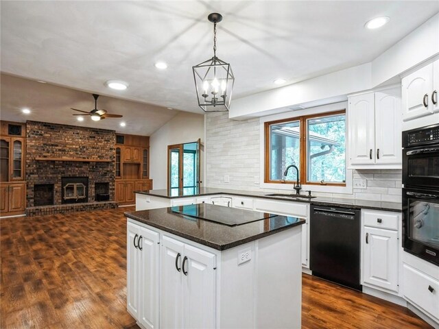 kitchen with white cabinetry, a center island, dark hardwood / wood-style floors, black appliances, and sink