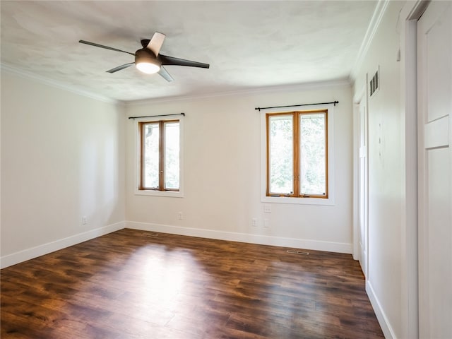 empty room featuring ceiling fan, crown molding, and dark hardwood / wood-style flooring