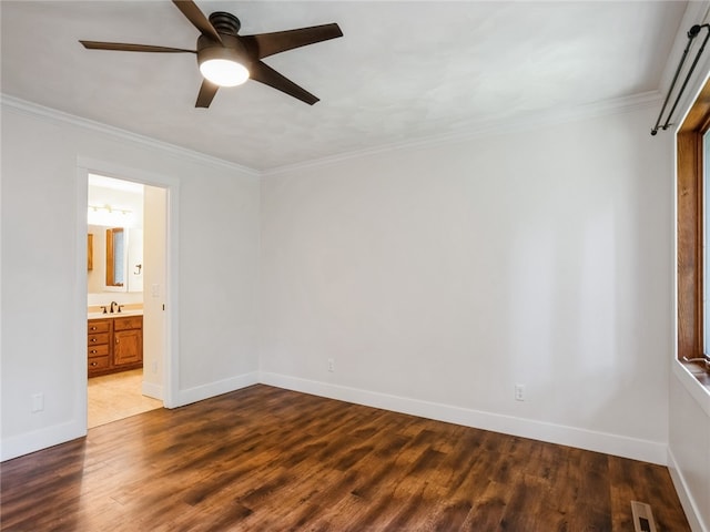 unfurnished bedroom featuring ensuite bath, crown molding, ceiling fan, and wood-type flooring