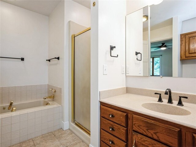 bathroom with tile patterned flooring, independent shower and bath, vanity, and ceiling fan