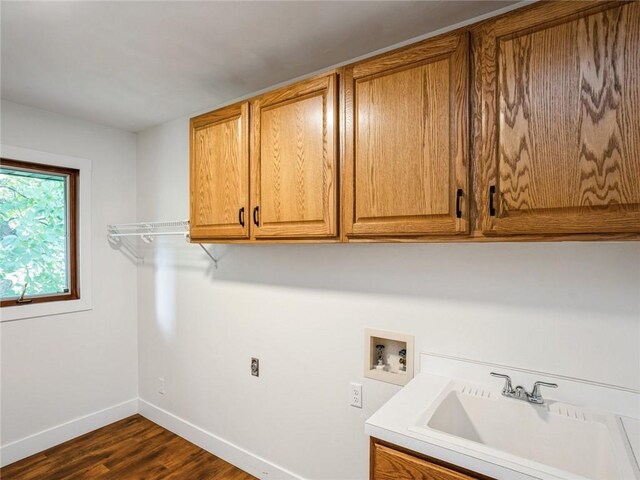 laundry area with washer hookup, dark hardwood / wood-style flooring, sink, and cabinets