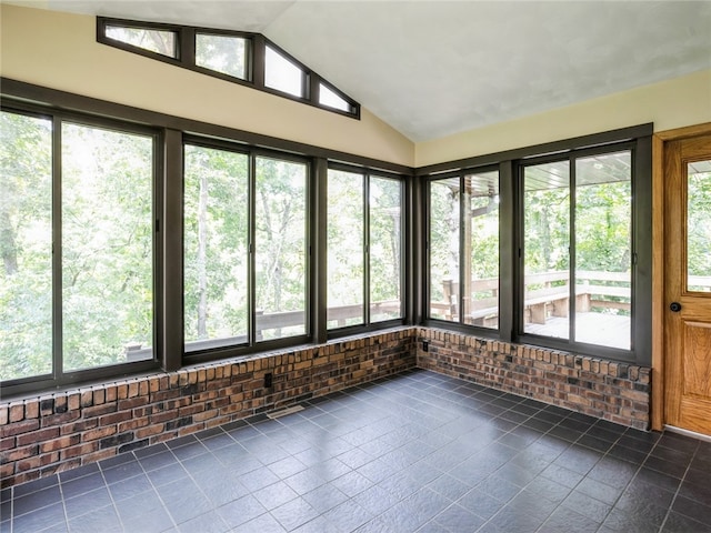 unfurnished sunroom with a healthy amount of sunlight and vaulted ceiling