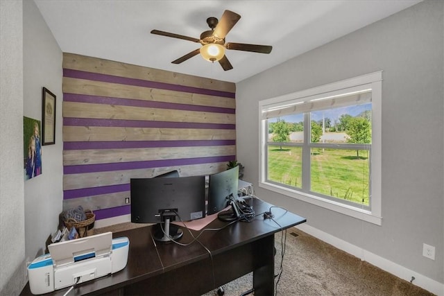 carpeted office space featuring ceiling fan