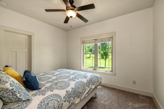 bedroom featuring ceiling fan and carpet