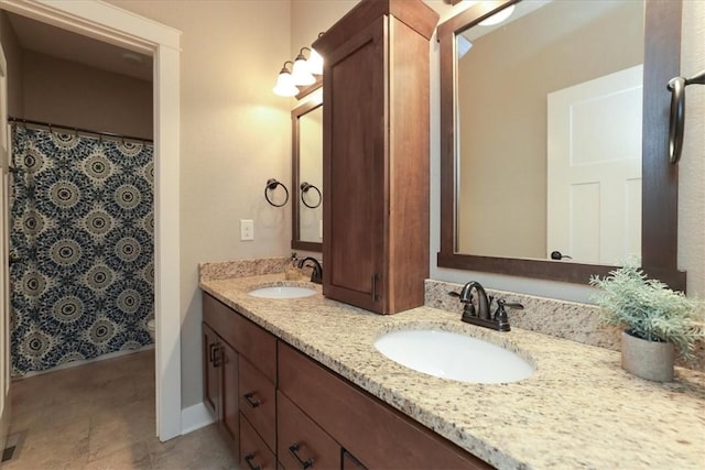 bathroom with tile patterned flooring and double vanity