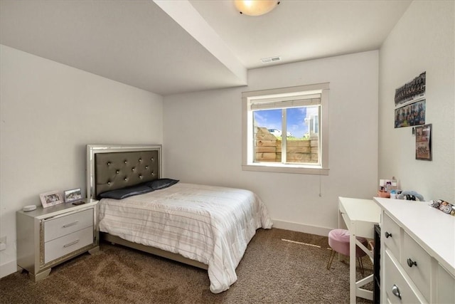 bedroom featuring dark carpet