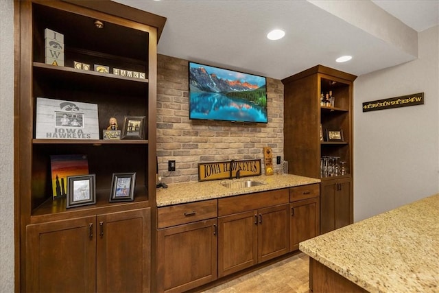 bar with sink and light stone countertops