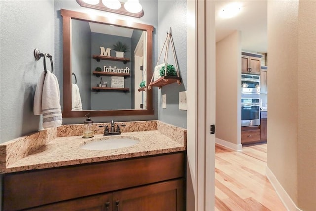 bathroom featuring vanity and wood-type flooring