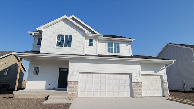 craftsman inspired home featuring a garage and central air condition unit