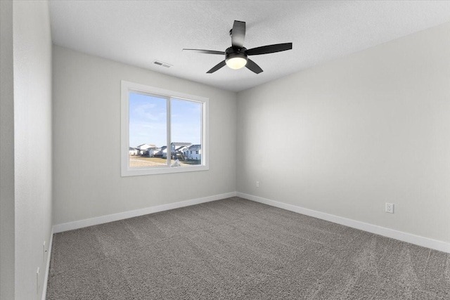 unfurnished room with ceiling fan, carpet flooring, and a textured ceiling