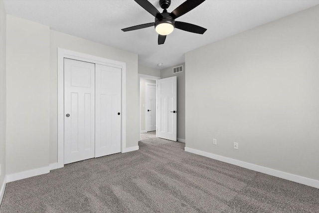 unfurnished bedroom featuring ceiling fan, carpet floors, and a closet