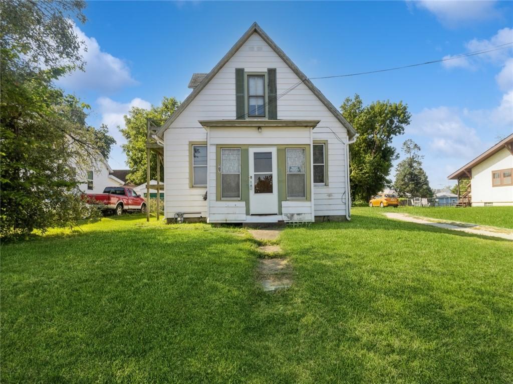 rear view of house featuring a lawn