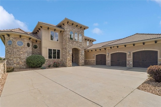 mediterranean / spanish-style home featuring a garage