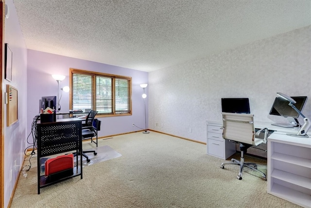 carpeted home office with a textured ceiling