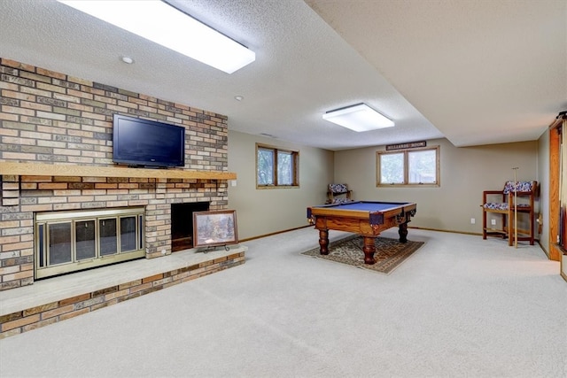 recreation room featuring pool table, carpet floors, a fireplace, and a textured ceiling