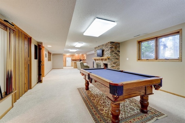 game room with light colored carpet, a brick fireplace, pool table, and a textured ceiling