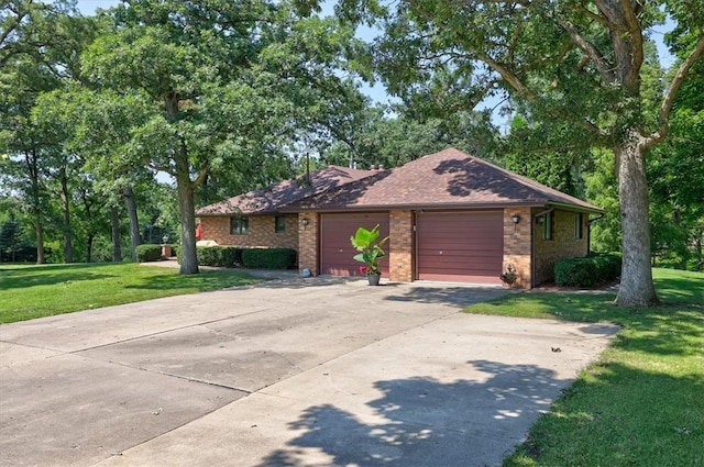 ranch-style house featuring a front yard and a garage