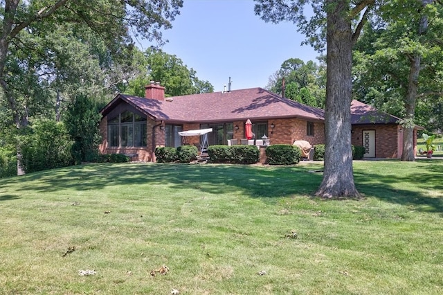 ranch-style home featuring a front yard