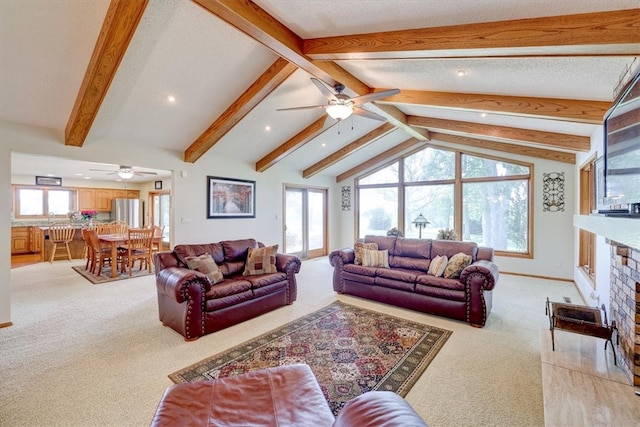 living room with light colored carpet, ceiling fan, lofted ceiling with beams, and a fireplace