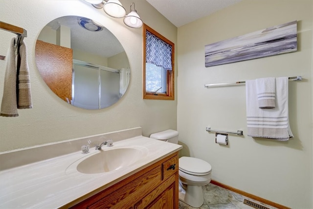 bathroom with tile patterned flooring, vanity, toilet, and a textured ceiling