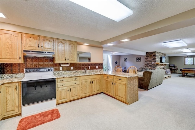 kitchen featuring light carpet, a textured ceiling, range hood, white electric stove, and kitchen peninsula