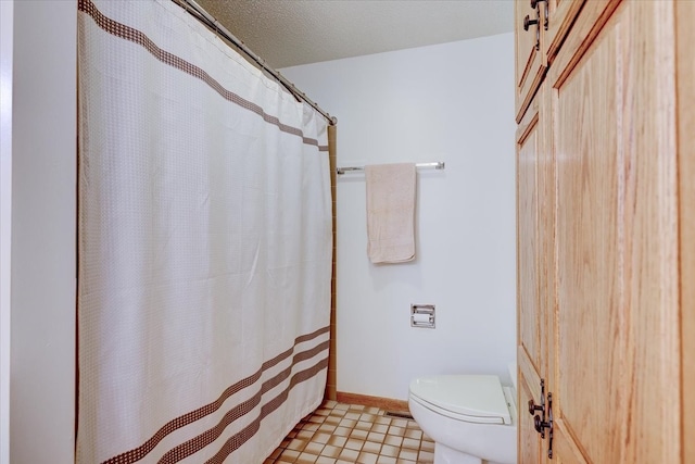 bathroom featuring tile patterned flooring and toilet