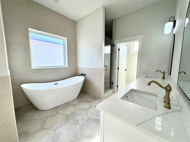 bathroom featuring vanity, plus walk in shower, tile patterned flooring, and tile walls