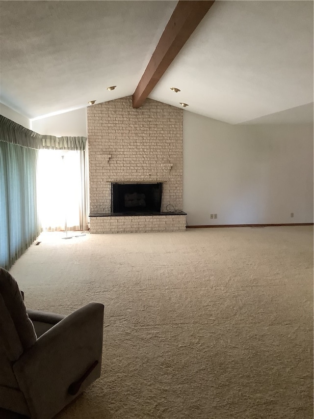 carpeted living room with a fireplace, lofted ceiling with beams, and brick wall