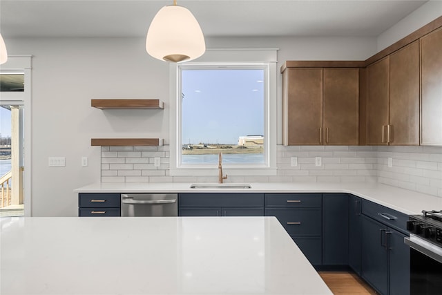 kitchen featuring sink, decorative backsplash, pendant lighting, and stainless steel dishwasher