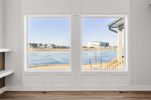 interior space featuring a water view and hardwood / wood-style floors