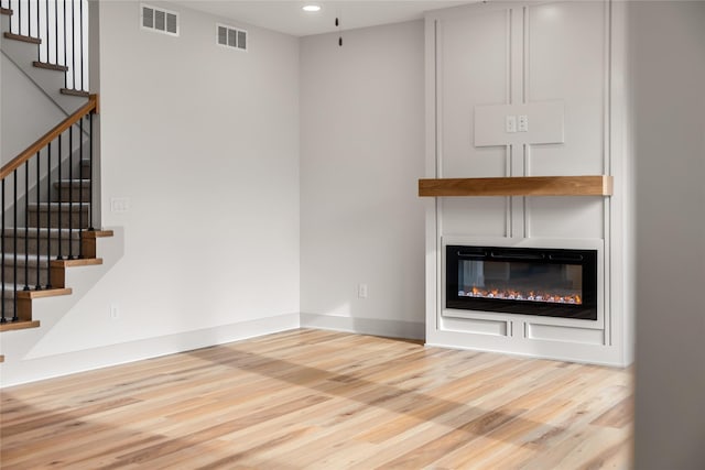 unfurnished living room featuring light wood-type flooring