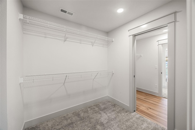 walk in closet featuring hardwood / wood-style flooring