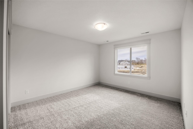 unfurnished room featuring carpet